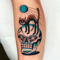 a tattoo of a skull with a cat on it